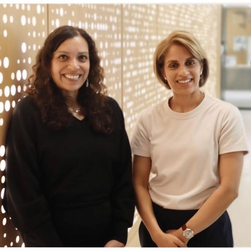 Two women smile at the camera