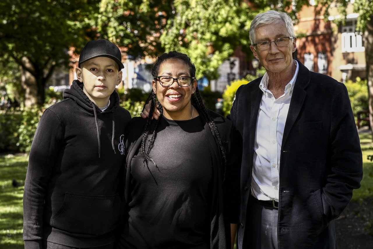 Conor, Jules and Paul O'Grady smiling at camera