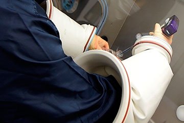 Scientist in lab wearing protective personal equipment