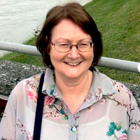 A woman with brown hair smiling