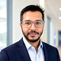 A man with short hair and glasses smiling