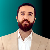 A man with short brown hair and beard is smiling