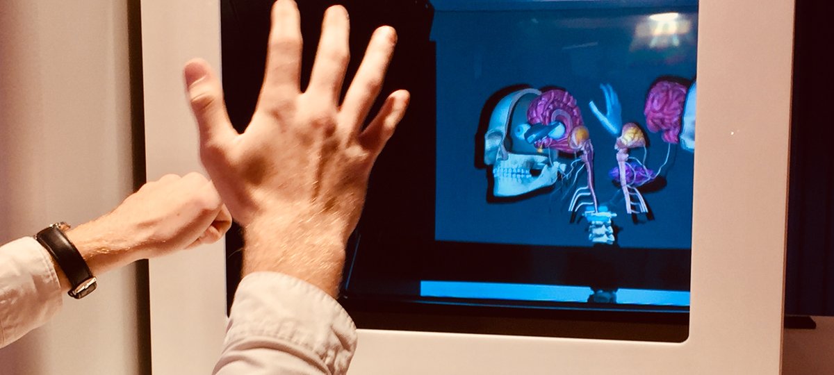 Hands in front of a virtual reality screen