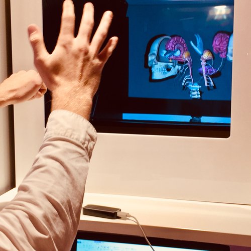 Hands in front of a virtual reality screen