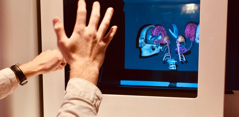 Hands in front of a virtual reality screen