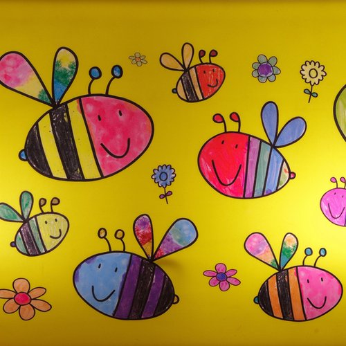 Wall decorated in bumblebees and flowers that appear hand drawn and colored by children