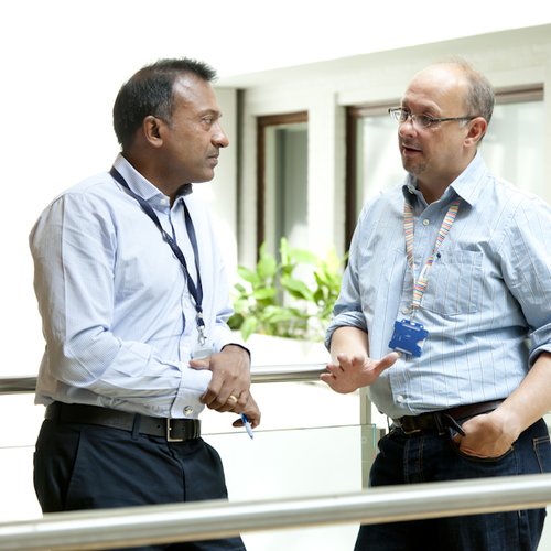 Two men, Bobby Gaspar on left, and Adrian Thrasher on right, in conversation in ICH lobby