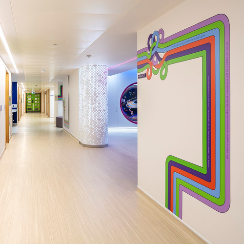 Bright and light corridor showing rainbow lines and space theme.