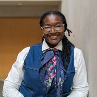 Dr Azeezat Aminu posing for a picture on a staircase.