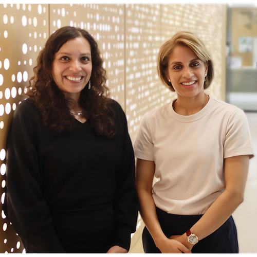 Two women smile at the camera