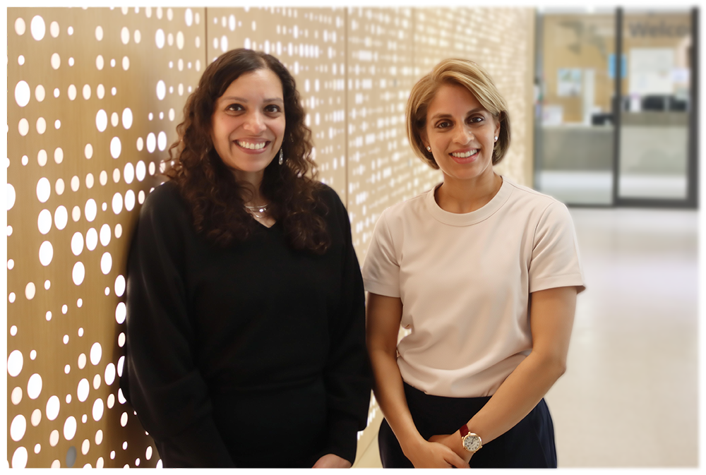 Two women smile at the camera