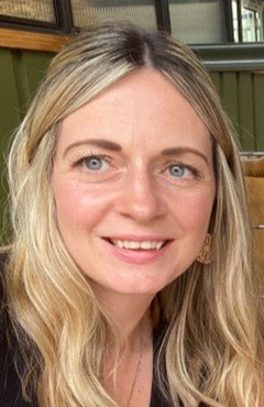 An image of a staff member smiling