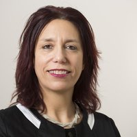 A woman with dark red hair smiling