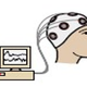 A computer and a head with wires attached to it
