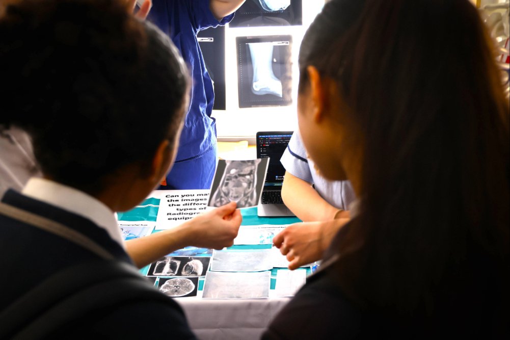 Two students looking at an xray and scan images