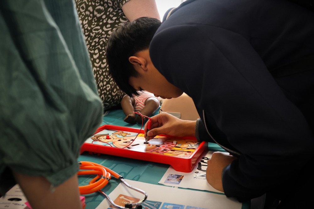 A student playing the boardgame Operation