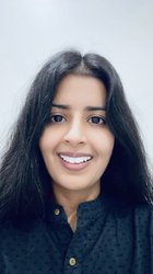 A woman with long hair is smiling