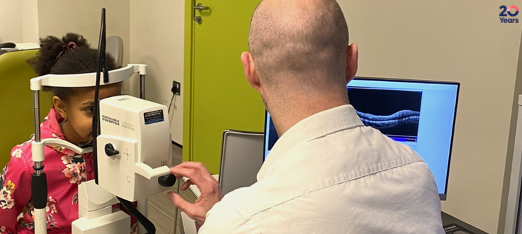 A child having their eyes examined by a doctor