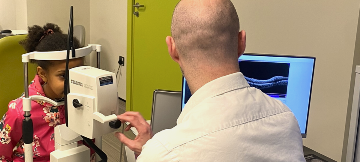 A child having their eyes examined by a doctor