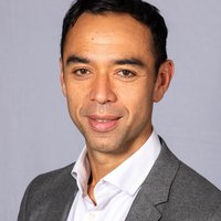 A man wearing a suit, smiling