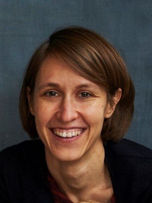A woman smiles at the camera