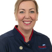 A woman with blonde hair is smiling