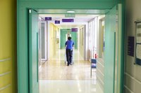 Staff member walking down hospital corridor