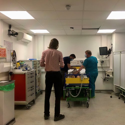 Medical students work in a team with a member of simulation faculty to manage an unwell patient