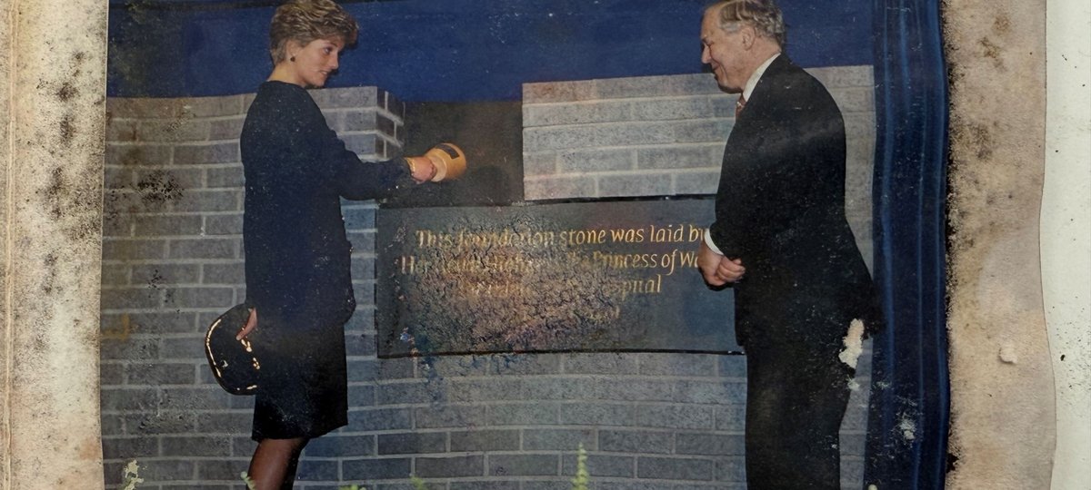 A photograph showing Late Princess of Wales, with another person by the foundation stone of the Variety Club Building