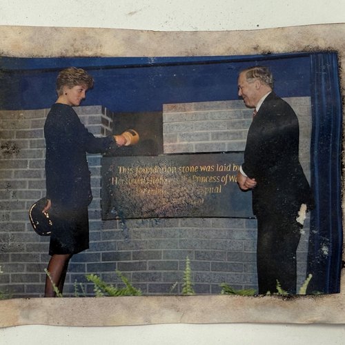 A photograph showing Late Princess of Wales, with another person by the foundation stone of the Variety Club Building