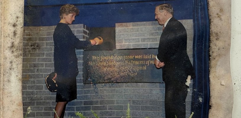 A photograph showing Late Princess of Wales, with another person by the foundation stone of the Variety Club Building