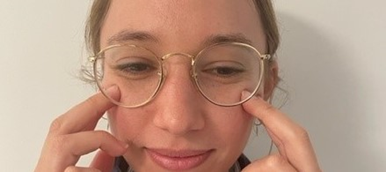 A person touching their cheeks with their fingers