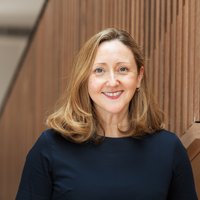 Professor Claire Booth, Clinical Academic Lead for the Cell and Gene Therapy Service at GOSH, stood in ZCR wearing a black top and smiling