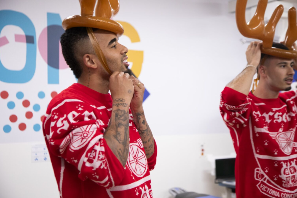 two arsenal mens players with inflatable antlers