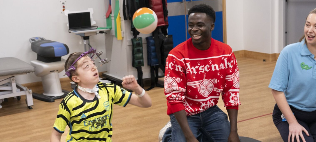 arsenal player and patient in physio gym playing sat down volley ball