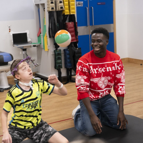 arsenal player and patient in physio gym playing sat down volley ball