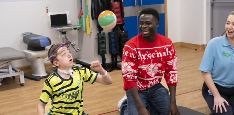 arsenal player and patient in physio gym playing sat down volley ball