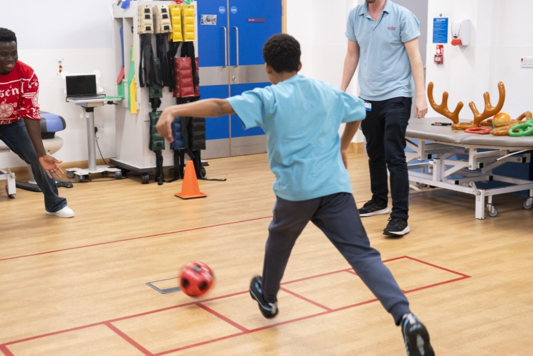 boy taking penalty shot against arsenal mens player
