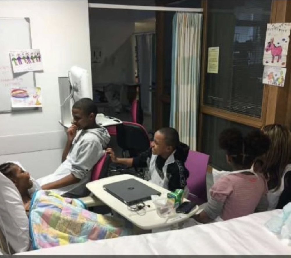 Family in hospital room talking