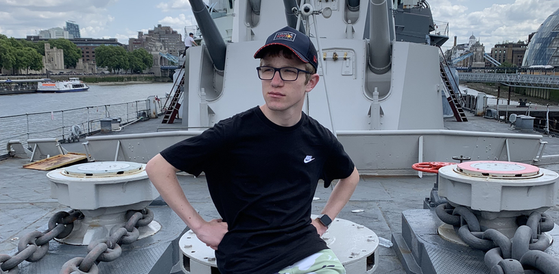 Will sitting on the front of HMS Belfast on the river Thames