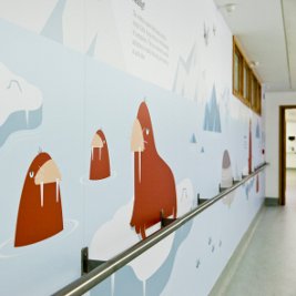 Sea animals illustrated on a wall. Brown walrus standing on blocks of ice.