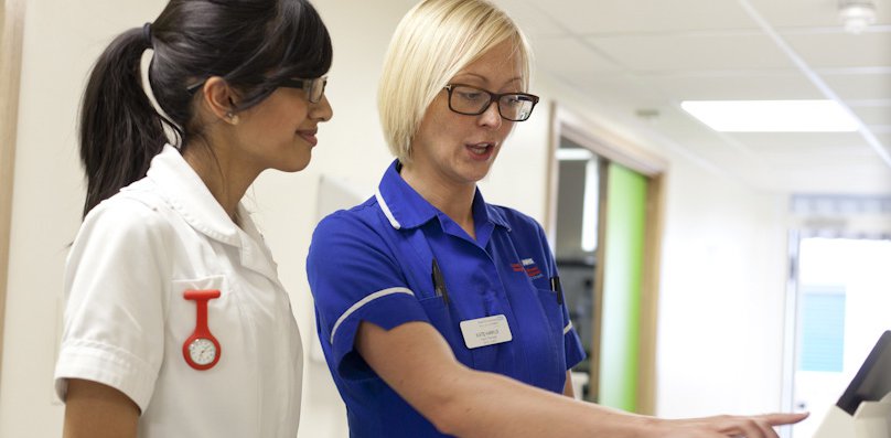 Two nurses with a computer