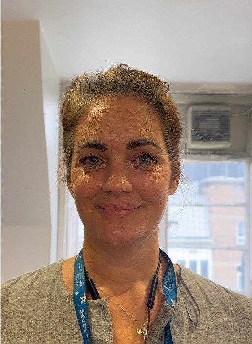 An image of a staff member smiling